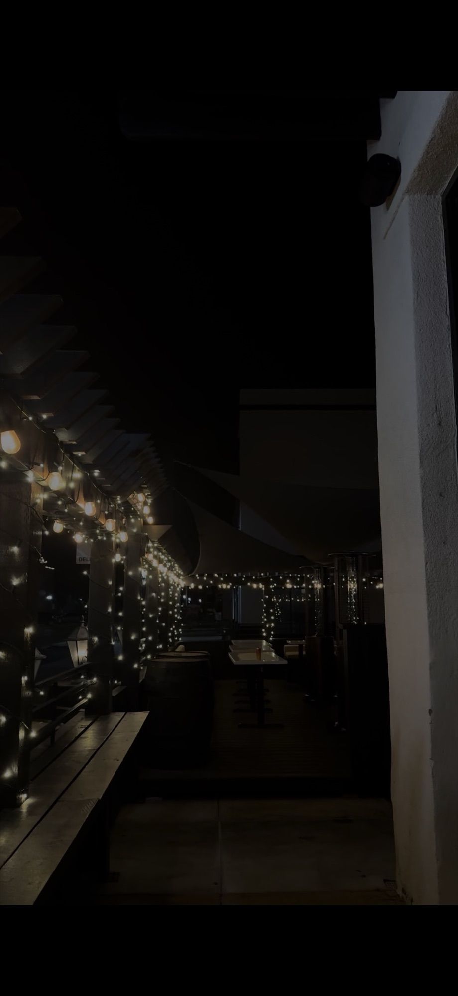 String light canopy over a restaurant patio at night